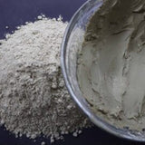 Picture of raw fresh green Amazon Forest Green Clay with bowl of wet clay for facial mask.