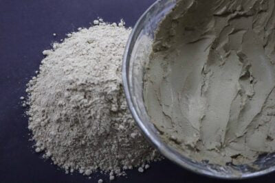 Picture of raw fresh green Amazon Forest Green Clay with bowl of wet clay for facial mask.