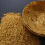 Picture of raw fresh yellow Amazon Forest Yellow Clay with bowl of wet clay for facial mask.